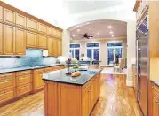  ??  ?? The home’s kitchen impresses with its size and amenities, including granite countertop­s.