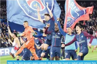  ??  ?? PARIS: Paris Saint-Germain’s players celebrate after winning the French L1 football match between Paris Saint-Germain (PSG) and Monaco (ASM) on Sunday, at the Parc des Princes stadium in Paris.— AFP