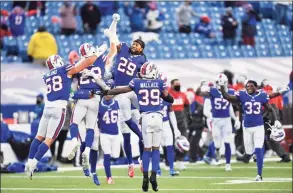  ?? Adrian Kraus / Associated Press ?? The Buffalo Bills’ Matt Milano ( 58) and Josh Norman ( 29) celebrate after an NFL wild- card playoff victory against the Indianapol­is Colts Saturday.