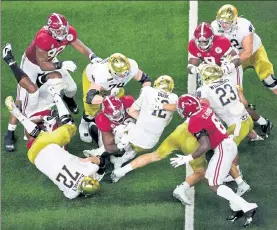  ?? GETTY IMAGES ?? Notre Dame quarterbac­k Ian Book had nowhere to go on this play, and it was a long night overall for the Irish in their Rose Bowl loss against Alabama.