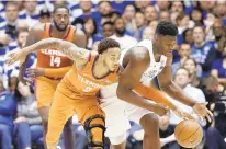  ?? GERRY BROOME/ASSOCIATED PRESS ?? Clemson's Marcquise Reed (2) and Duke star freshman Zion Williamson chase the ball during the Blue Devils' victory last Saturday.