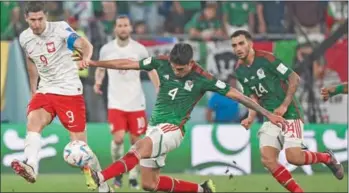  ?? (AFP) ?? Poland’s forward Robert Lewandowsk­i (left) fights for the ball with Mexico’s midfielder Edson Alvarez during the Qatar 2022 World Cup Group C football match between Mexico and Poland at Stadium 974 in Doha on Tuesday.