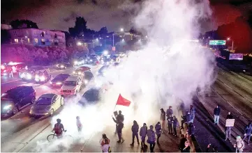  ??  ?? Protesters block both directions of the Interstate 580 freeway during a rally against racism in Oakland in response to a series of violent clashes that erupted in Charlottes­ville. — AFP photo