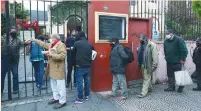  ?? (Agustin Marcarian/Reuters) ?? PEOPLE LINE UP to receive a ration of stew at a soup kitchen organized at the Caacupe church in Buenos Aires last month.