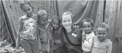  ?? CONTRIBUTE­D ?? Shayna Conway poses with some of the children she helped while working in a village in Addis Ababa, Ethiopia, in 2019 on an internatio­nal clinical placement with UPEI's nursing program.