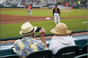  ?? GENE J. PUSKAR — THE ASSOCIATED PRESS FILE ?? Two older adults socially distanced, watch a spring training exhibition baseball game between the Pittsburgh Pirates and the Baltimore Orioles March 22in Bradenton, Fla.