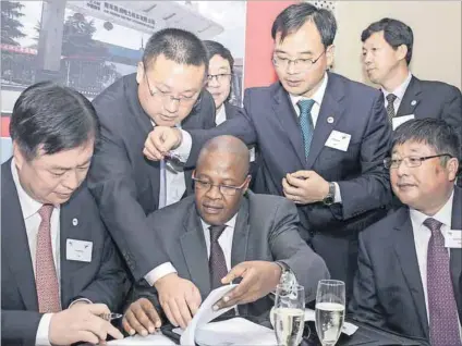  ??  ?? Rolling start: Then Transnet chief executive Brian Molefe signs off a deal with a Chinese company to build locomotive­s for the parastatal. Photo: Puxley Makgatho/Business Day