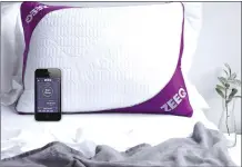  ?? Associated Press photos ?? This photo provided by REM-Fit shows the Zeeq pillow, which monitors snoring and can gently vibrate to nudge someone into a different sleep position. The pillow can also play your favorite music, audio books and more without disturbing anyone next to...