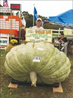  ?? Associated Press photo ?? In this Saturday photo provided by Susan Jutras, Joe Jutras stands with his world-recordbrea­king, 2,118-pound squash, following a weigh-in at Frerichs Farm in Warren, R.I. Jutras has become the first grower in the world to achieve a trifecta in the...