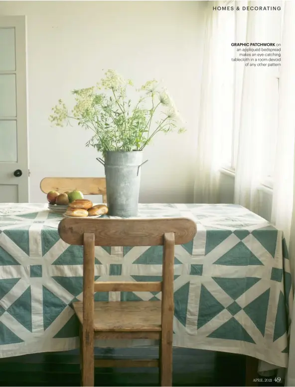  ??  ?? GRAPHIC PATCHWORK ON AN APPLIQUÉD BEDSPREAD MAKES AN EYE-CATCHING TABLECLOTH IN A ROOM DEVOID OF ANY OTHER PATTERN