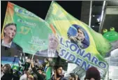  ?? NACHO DOCE / REUTERS ?? Supporters of Jair Bolsonaro celebrate on Sunday as the longtime lawmaker is declared winner of the nation’s presidenti­al race, in Sao Paulo, Brazil.