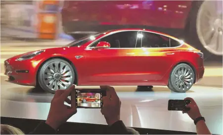  ?? AP FILE PHOTO ?? SLEEK: Tesla Motors’ Model 3 sedan is shown off at the Tesla Motors design studio in Hawthorne, Calif.