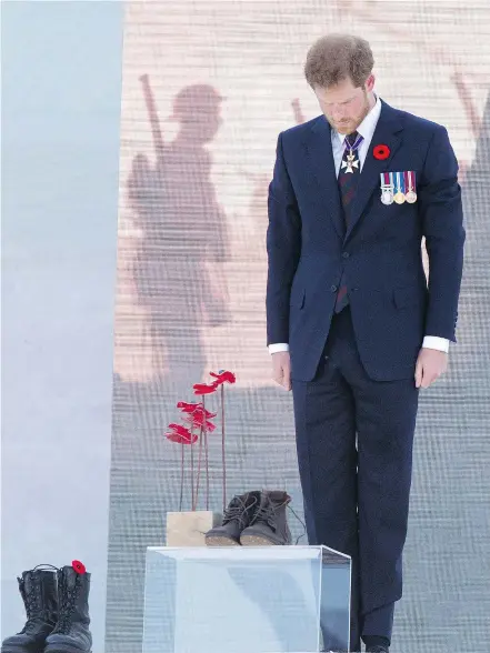  ?? — GETTY IMAGES ?? Prince Harry of Britain pays his respects Sunday at the Vimy Memorial, at the site in northern France where 100 years ago Canadians stormed and took a ridge the German army had held since the early months of the First World War.
