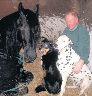  ??  ?? Carriage driver Mark Evans with his horse and dogs