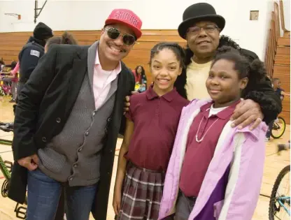  ??  ?? Ten-year-olds Lailah Johnson (center) and Courmya Davis with Marlon (left) and Tito Jackson at the John Will Anderson Boys & Girls Club in Gary, Indiana, on Wednesday. With their brother Jackie (below), the Jacksons donated 170 bicycles to kids during their visit.