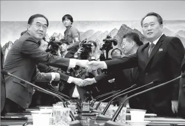  ?? YONHAP VIA REUTERS ?? Ri Son-gwon (right), chairman of the DPRK’s Committee for the Peaceful Reunificat­ion of the Fatherland, shakes hands with the ROK’s Unificatio­n Minister Cho Myoung-gyon during their meeting at the truce village of Panmunjom on Monday.