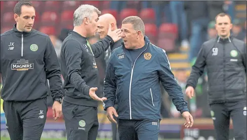  ??  ?? Motherwell boss Mark McGhee makes his feelings known to Celtic’s backroom staff as Parkhead No.2 Chris Davies can be seen in the background, right