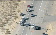  ?? L.E. BASKOW — LAS VEGAS REVIEW-JOURNAL VIA AP, FILE ?? Nevada Highway Patrol investigat­e the scene of a fatal crash involving multiple bicyclists and a box truck along U.S. Highway 95 southbound near Searchligh­t, Nev.