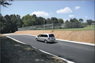  ?? The Sentinel-Record/Mara Kuhn ?? PROJECT ROADWAY: A new road connecting the main parking lot at Hot Springs World Class High School to Panama Street was one of several smaller projects the district recently completed following the approved millage increase last September. The increase...