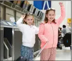  ??  ?? Mort than 180,000 passengers will be heading for Glasgow Airport over the weekend to head for sunnier climes. Zoe Lewis, 9, and Nicole Lewis, 7, get set to head to Orlando