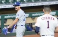  ?? AP ?? The Dodgers’ Joe Kelly and the Astros’ Carlos Correa exchange words Tuesday, emptying the benches in Houston.