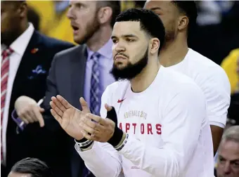  ?? ( AP) ?? RAPTORS guard Fred VanVleet applauds from the bench after receiving several stitches from an elbow to the face from Golden State Warriors guard Shaun Livingston during the second half of Game 4 of basketball’s NBA Finals, Friday, June 7, 2019, in Oakland, Calif.