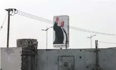  ?? AFP ?? Yemen’s President Abrabu Mansur Hadi, pictured on a billboard in Aden, praised Taez governor Amin Mahmood’s courage