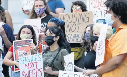  ??  ?? ABOVE: Homeless advocates on Wednesday rally outside Los Angeles City Hall in protest of a City Council vote that bans camping in many parts of the city.