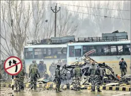  ?? PTI ?? Security personnel carry out the rescue and relief works at the site of a suicide attack at Lathepora Awantipora in Pulwama district of south Kashmir on February 14, 2019. At least 30 CRPF jawans were killed and dozens other injured when a CRPF convoy was attacked.