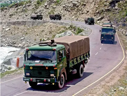  ?? — H.U. Naqash ?? An army convoy moves along the Srinagar-Leh National highway, in Ganderbal district of Central Kashmir, Wednesday. The Srinagar-Leh highway witnessed movement of huge military convoys on Wednesday. The police and other security forces had laid additional makeshift checkpoint­s on the stretch of the highway between Ganderbal town and Sonamarg resort.