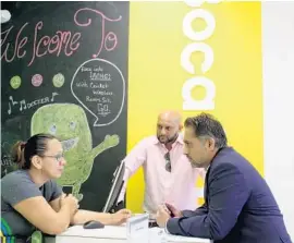  ?? LESLIE OVALLE/STAFF PHOTOGRAPH­ER ?? Fancy Guerra, left, CricketWir­eless store manager, Akif Ali, center, district manager, and Hassan Ahmad, right, vice president of sales discuss the company's upcoming expansion.