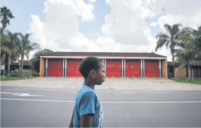  ?? Picture: Jacques Nelles ?? HOUSE OF BLUES. A boy walks past the Phillip-Nel Fire Station in Pretoria yesterday.