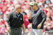  ?? Jeff Dean/Associated Press ?? Yankees manager Aaron Boone, right, speaks with umpire Brian O’Nora in the first inning against the Reds on Sunday. Boone was ejected by home plate umpire Emil Jimenez.