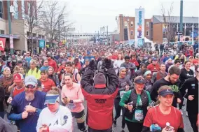  ?? PHOTOS BY BRANDON DAHLBERG / FOR COMMERCIAL­APPEAL.COM ?? Runners make their way across the starting line of the 2019 St. Jude Memphis Marathon.