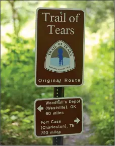  ??  ?? A sign marks the historic route of the Trail of Tears Friday as it passes through Pea Ridge National Military Park. The National Park Service and Trail of Tears Associatio­n are working to add more signs for Trail of Tears sites throughout Benton and...