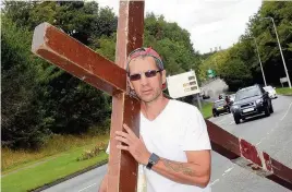  ??  ?? Clive Cornish from Ely, Cardiff who left Holyhead on his way to Cardiff carrying the Cross on his back - pictured here at Felinheli