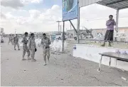  ?? REUTERS ?? Soldiers inspect the scene of a Houthi drone attack at a Yemeni government military parade at Al-Anad Air Base.