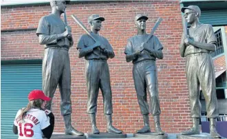  ?? MARY SCHWALM / BOSTON HERALD ?? ALL-TIME GREATS: Jessica Felis poses in her Andrew Benintendi jersey in front of the statues at Fenway Park yesterday.