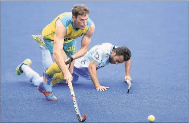  ?? AP ?? India’s Affan Yousuf battles for the ball with Australia’s Trent Mitton during their match at the Azlan Shah Cup in Ipoh.