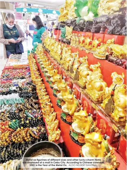  ?? ALDO NELBERT BANYNAL ?? Metal ox figurines of different sizes and other lucky charm items are displayed at a mall in Cebu City. According to Chinese calendar, 2021 is the Year of the Metal Ox.