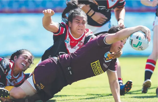  ?? Picture: BRETT COSTELLO ?? AND AGAIN: Broncos Heather Ballinger scores a try to put the Broncos further ahead of the Sydney Roosters at ANZ Stadium, Sydney.