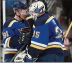  ?? The Associated Press ?? Canuck killers: Blues’ Vladimir Tarasenko (91) and goalie Ville Husso celebrate after defeating the Vancouver Canucks, Monday.