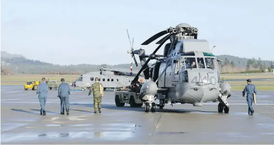  ??  ?? A Sea King is pulled from the hangar in preparatio­n for an exercise. The ability to fold the rotors allowed Sea Kings to fit on smaller ships at sea.