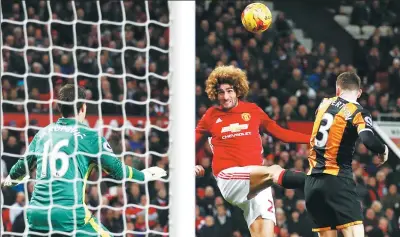  ?? PHIL NOBLE / REUTERS ?? Marouane Fellaini heads in Manchester United’s second goal against Hull City to secure a 2-0 English League Cup semifinal, first-leg victory over the Tigers at Old Trafford on Tuesday.