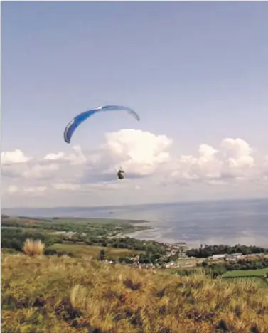  ??  ?? A competitor gets a great view of Lamlash Bay. Inset: Spectators watch the action from the hillside.