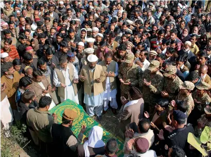  ?? People pray during the funeral for a soldier killed by Indian shelling, in the village of Solara, near Muzaffarab­ad, the capital of Pakistanic­ontrolled Kashmir, on Tuesday. — AP ??