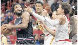  ?? MICHAEL LAUGHLIN/SUN SENTINEL ?? Heat forward Justise Winslow finds himself caught in traffic during Tuesday night's game.