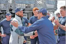  ??  ?? Niall Iain is welcomed aboard the US Coastguard cutter Diligence.