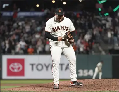  ?? PHOTOS BY JEFF CHIU — THE ASSOCIATED PRESS ?? Giants pitcher Kervin Castro celebrates after the Giants defeated the San Diego Padres to clinch a postseason berth on Monday.