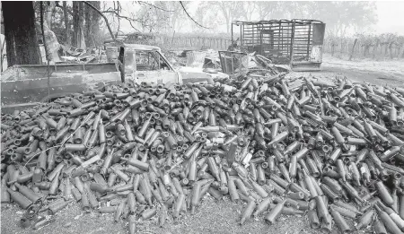  ?? TNS ?? Hundreds of wine bottles lie in the ruins of the fire-ravaged Helena View Johnston Vineyards near Calistoga, California.